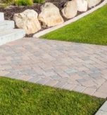 Settled and sunken paver patio with uneven joints awaiting repair at a Portland, Oregon home