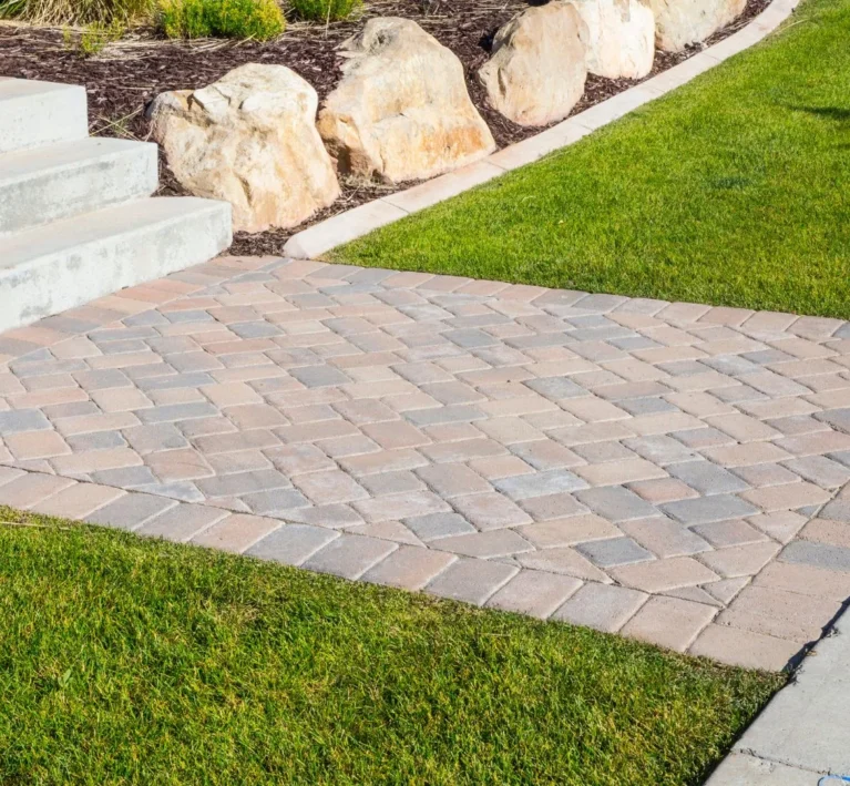 Settled and sunken paver patio with uneven joints awaiting repair at a Portland, Oregon home
