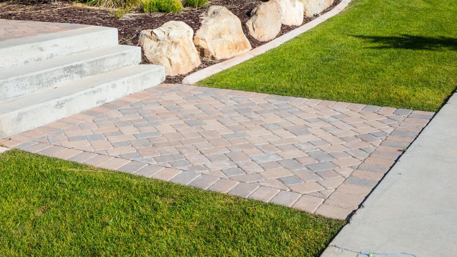 Settled and sunken paver patio with uneven joints awaiting repair at a Portland, Oregon home