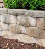 Leaning segmental block retaining wall showing outward movement at a Portland metro, Oregon property