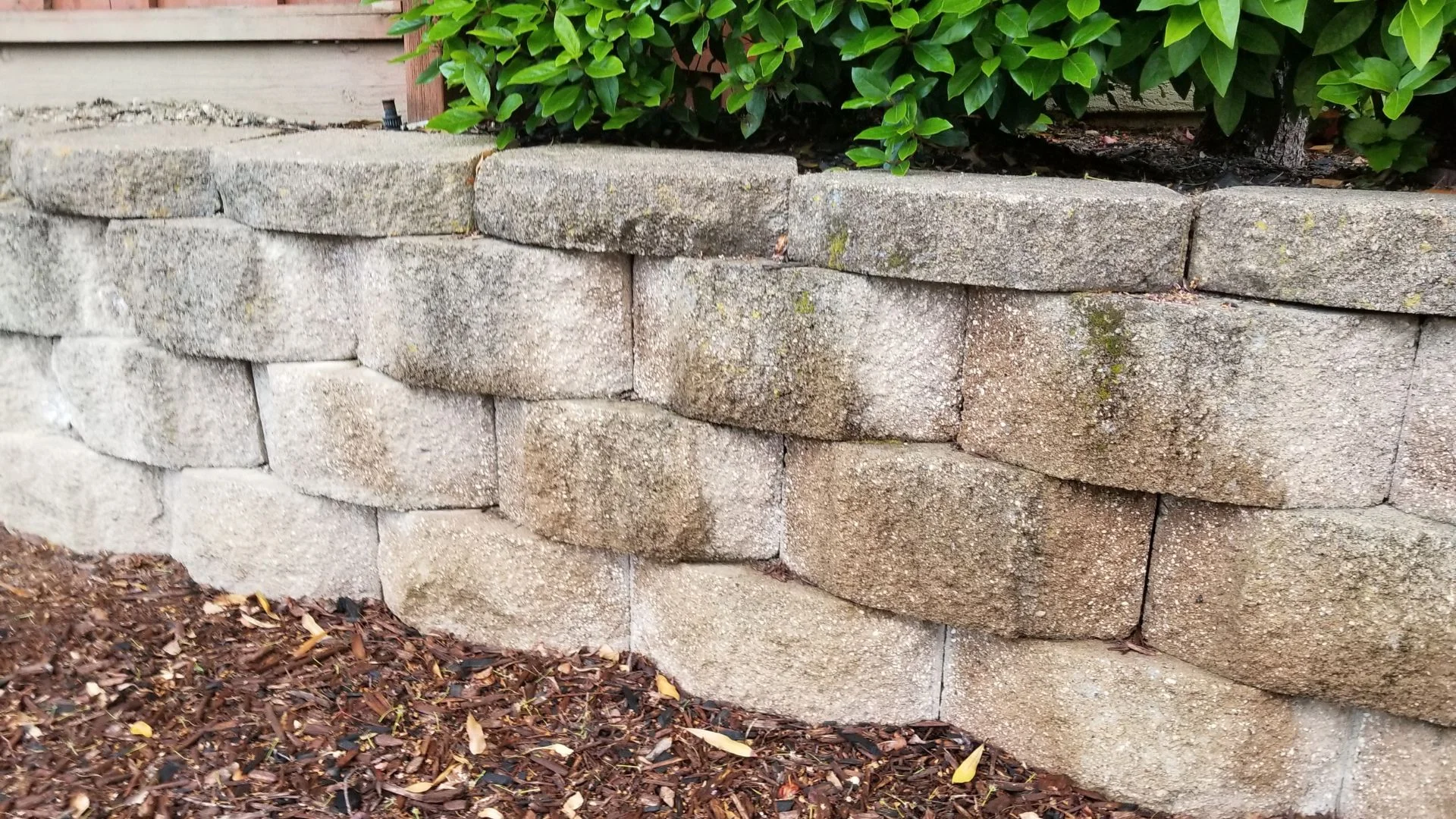 Leaning segmental block retaining wall showing outward movement at a Portland metro, Oregon property