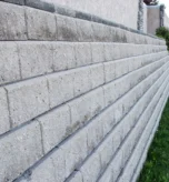 Segmental block retaining wall under construction on a sloped Lake Oswego, Oregon property