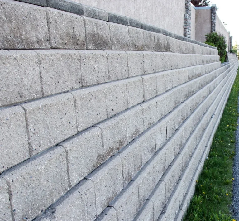 Segmental block retaining wall under construction on a sloped Lake Oswego, Oregon property