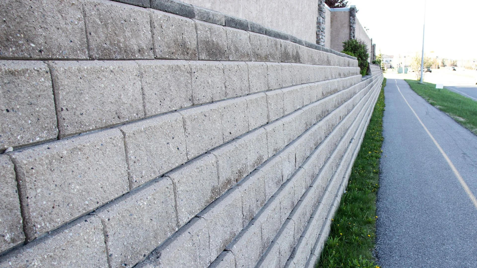 Segmental block retaining wall under construction on a sloped Lake Oswego, Oregon property