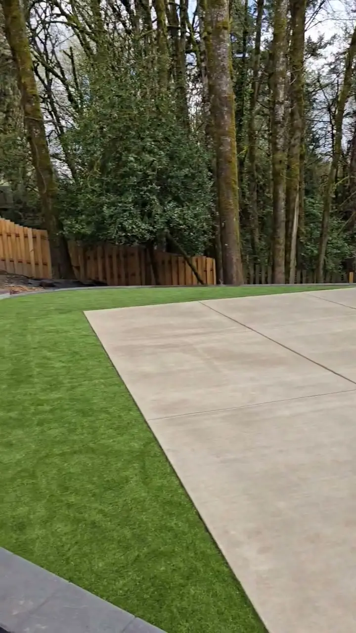 Portland backyard lawn and concrete patio in a wooded setting