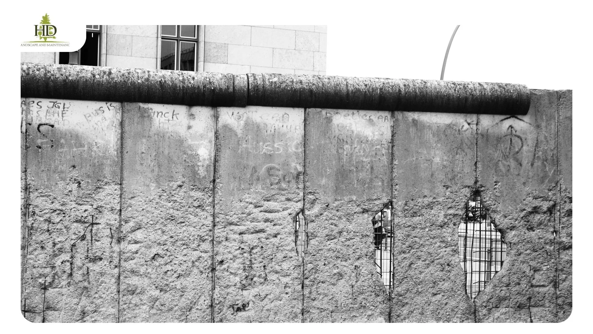 Retaining wall running along a residential property boundary between two Oregon homes at different grades